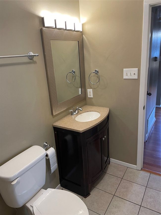 Bathroom featuring toilet, vanity, and tile patterned floors | Image 15