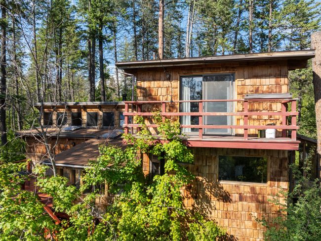 View of property exterior featuring a wooden deck | Image 70