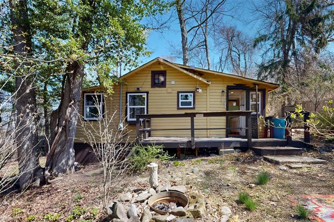 Rustic home featuring a wooden deck and an outdoor fire pit | Image 20