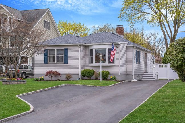View of front of house featuring a front yard, a shingled roof, and a chimney | Image 7