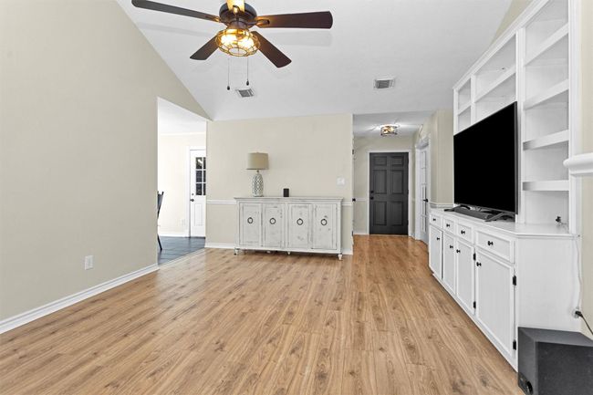 This home features stylish and low-maintenance laminate and tile flooring throughout, offering a cohesive and modern look. | Image 7