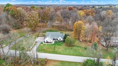 Enjoy a breathtaking aerial view of this stunning .75-acre property, showcasing a lush backyard oasis surrounded by natural beauty | Image 2