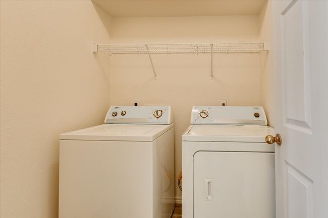 Laundry area featuring washer and clothes dryer | Image 24
