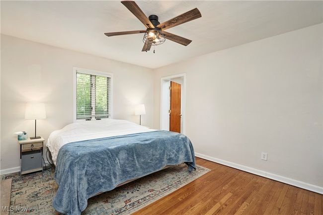 Bedroom featuring baseboards, wood finished floors, and ceiling fan | Image 17
