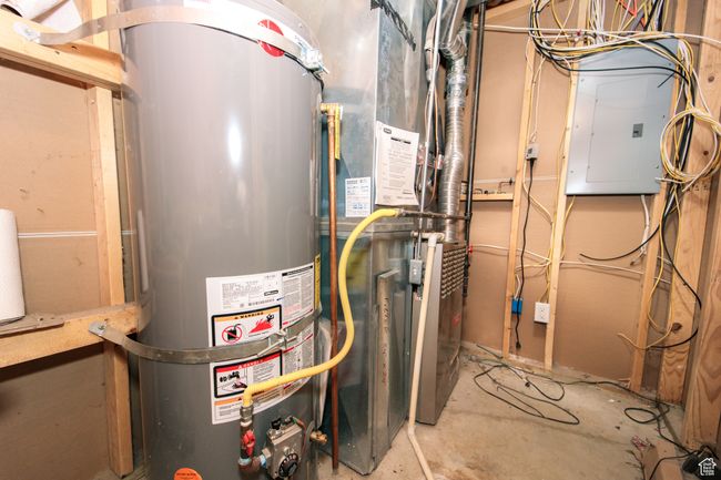 Utility room featuring gas water heater, Gas central Furnace and electric panel | Image 32