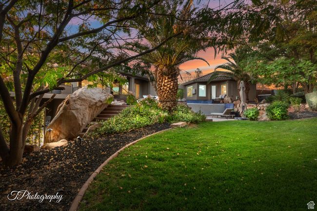 Rear view of house with a lawn, stairs, and stucco siding | Image 58