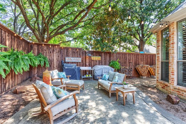 Fenced backyard with outdoor lounge area, a grill, and a patio | Image 34