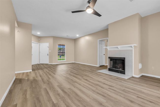 Alternative view of the spacious living room and den in the front of the home! | Image 5