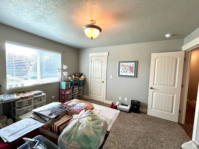 Bedroom featuring a textured ceiling and carpet flooring | Image 18
