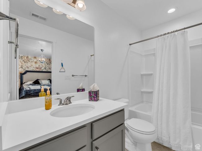 Full bathroom featuring vanity, shower / tub combo with curtain, connected bathroom, and recessed lighting | Image 33