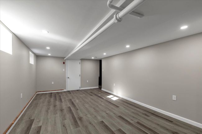 Basement featuring light wood-type flooring | Image 14