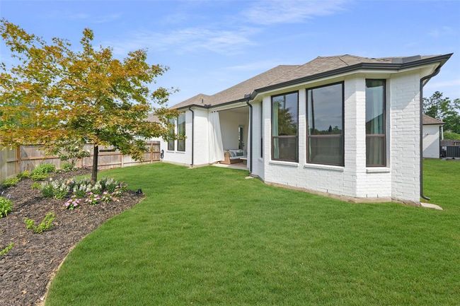 Elevate your backyard oasis with vibrant flower beds that add warmth and charm. | Image 38