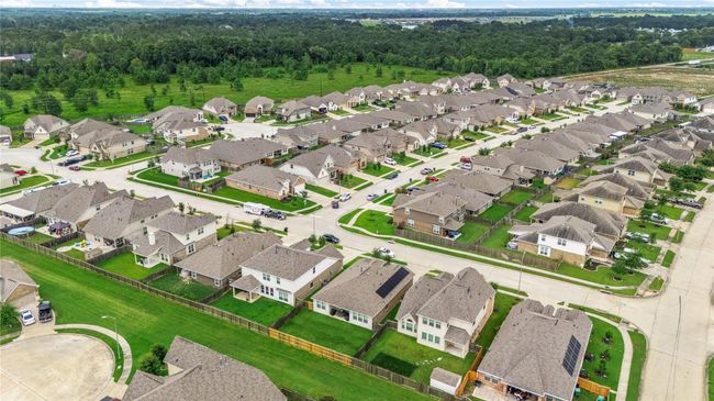 Amazing aerial shot of this lovley home situated on a quiet street in the community of Kodiak Crossing zoned to Crosby ISD. Lush landscaping, well manicured front lawn and a wonderful backyard with no back neighbors. | Image 22