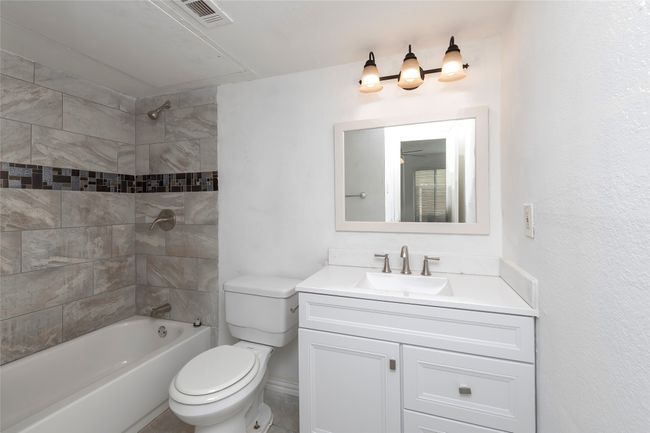 Bathroom featuring vanity, visible vents, shower / tub combination, and toilet | Image 13