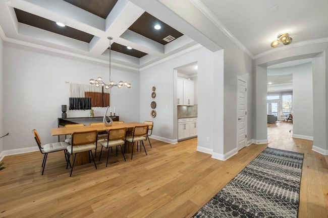 A wonderfully open concept dining area that seamlessly flows into a gourmet kitchen is the perfect floorplan for hosting family and friends. | Image 7