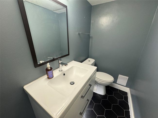 Bathroom with tile patterned floors, toilet, vanity, and baseboards | Image 8