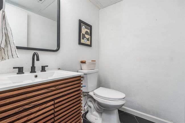 Bathroom featuring toilet, vanity, tile patterned floors, and baseboards | Image 11