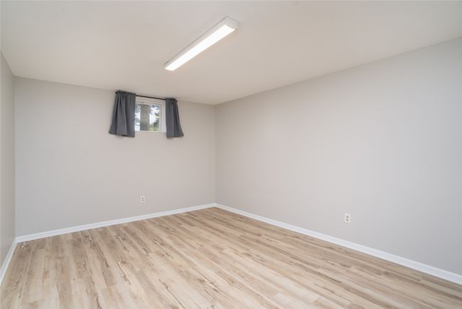 Empty room with baseboards and light wood-style floors | Image 26