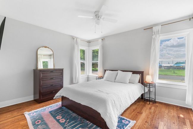 Large primary bedroom has beautiful windows that flood the space with natural light. | Image 20