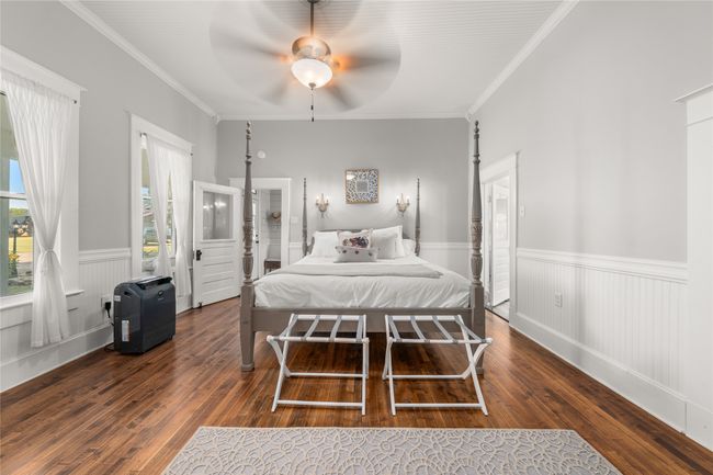Bedroom featuring hardwood / wood-style flooring, wainscoting, ornamental molding, and ceiling fan | Image 16