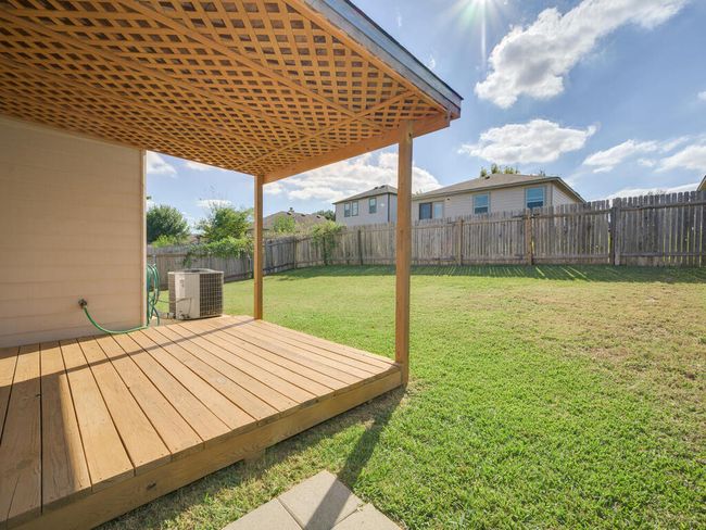 Wooden deck with a fenced backyard. | Image 24