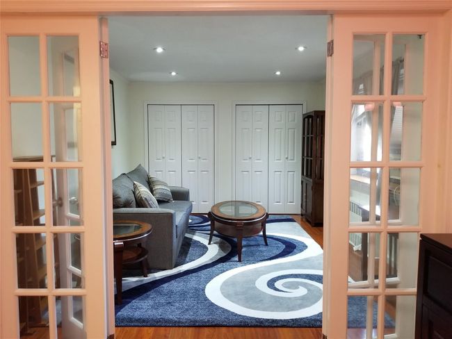 Living room with wood finished floors and french doors | Image 5