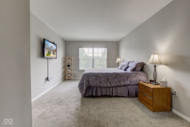 bedroom with light colored carpet | Image 13