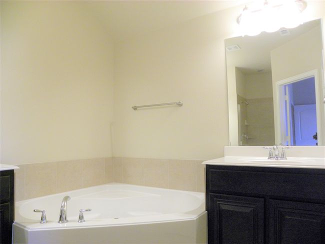 Full bathroom with vanity and a garden tub | Image 28