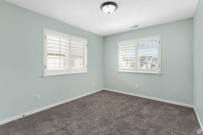 Spare room featuring carpet floors, baseboards, and visible vents | Image 8