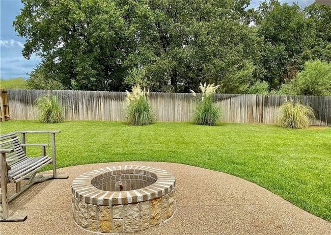 Fenced backyard with a fire pit | Image 21