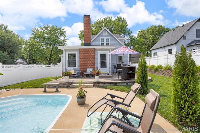 Back of property featuring a patio area, a fenced backyard, and a chimney | Image 42