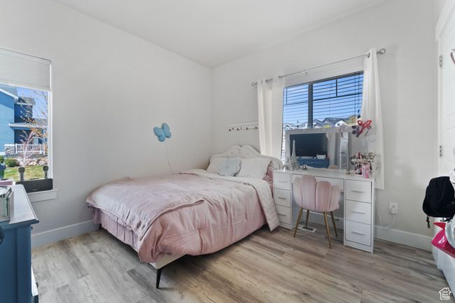 Bedroom featuring baseboards and wood finished floors | Image 10