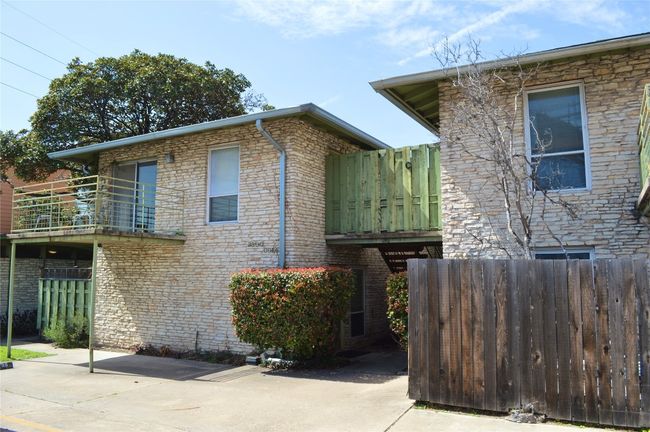 View of side of home with a balcony, a patio area, and fence | Image 12