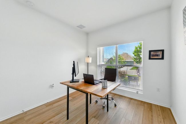 Home office with light wood finished floors and baseboards | Image 17