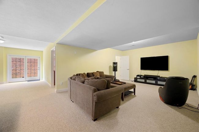 A large recreational space to relax or entertain. The door leads to the deck and yard. | Image 36