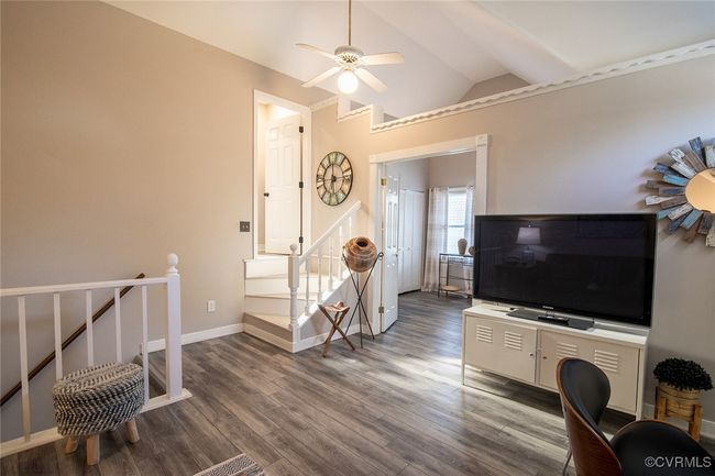 Living room with ceiling fan, baseboards, lofted ceiling, and wood finished floors | Image 28