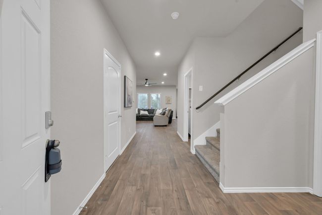 Upon entry, you’ll be welcomed by a large bright foyer that opens seamlessly into the main living areas. Notice the vinyl floors take your eyes straight out into your backyard view. | Image 4