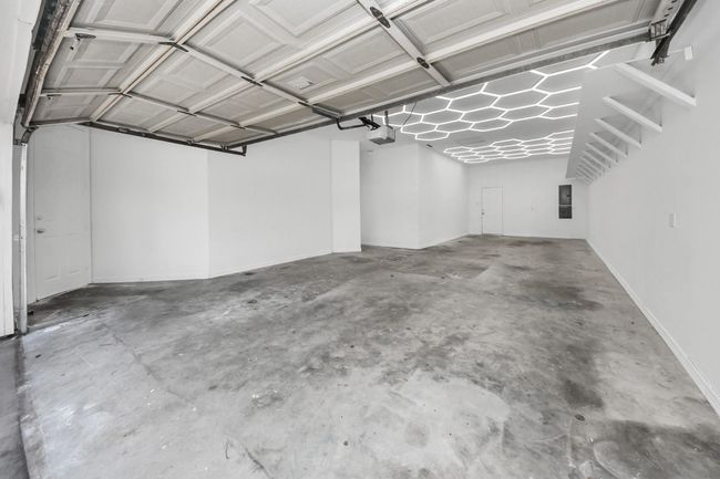 Garage with honeycomb lighting stores up to 3 vehicles | Image 4