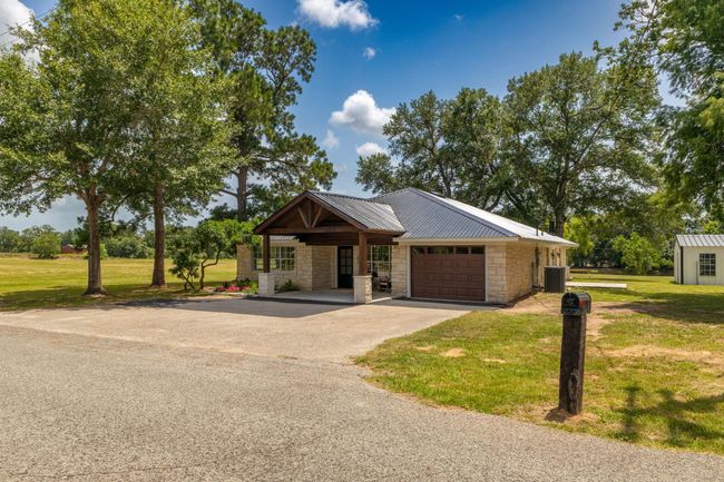 Charming home with modern features, nestled in the serene countryside. Enjoy a spacious yard, mature trees, and a welcoming front porch. Ideal for peaceful living. | Image 9