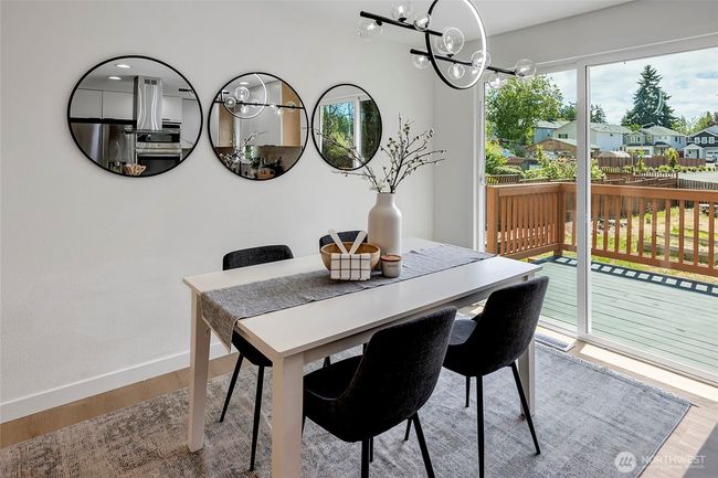 Dining room with slider that opens to large deck. | Image 10