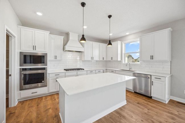Undermount sink and pull out faucet make clean up a breeze. Photo of model home, colors and finishes will vary. | Image 10