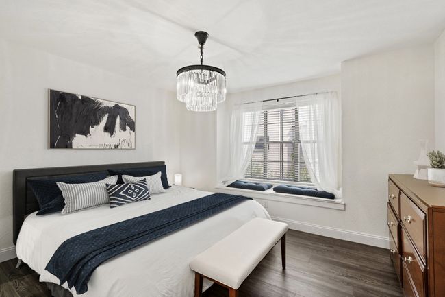 Bedroom with chandelier & window seat with extra storage | Image 9