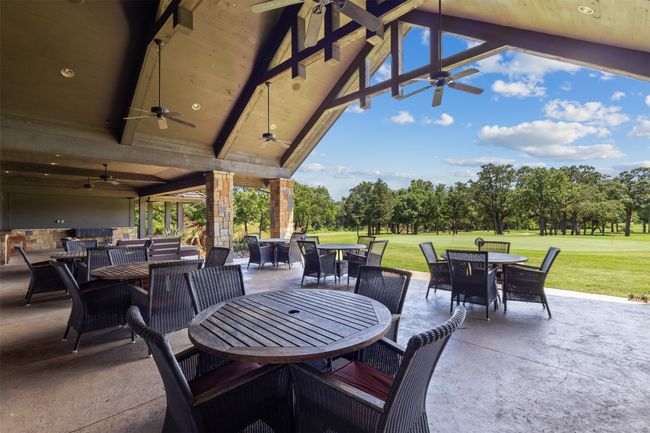 View of patio / terrace featuring outdoor dining space, ceiling fan, and view of scattered trees | Image 10