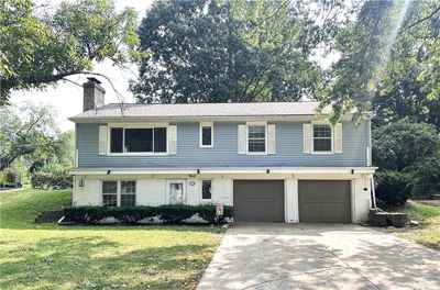 View of front of house with a garage and a front yard | Image 1