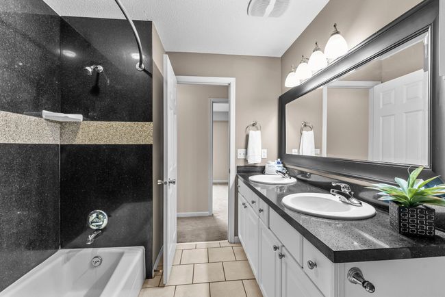 Main bath features granite countertop and maintenance free granite tub surround | Image 7