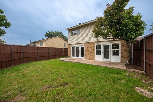 Rear view of house featuring a patio area, brick siding, and french doors | Image 34