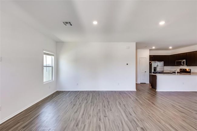 Unfurnished living room with light wood-style floors, recessed lighting, and baseboards | Image 4