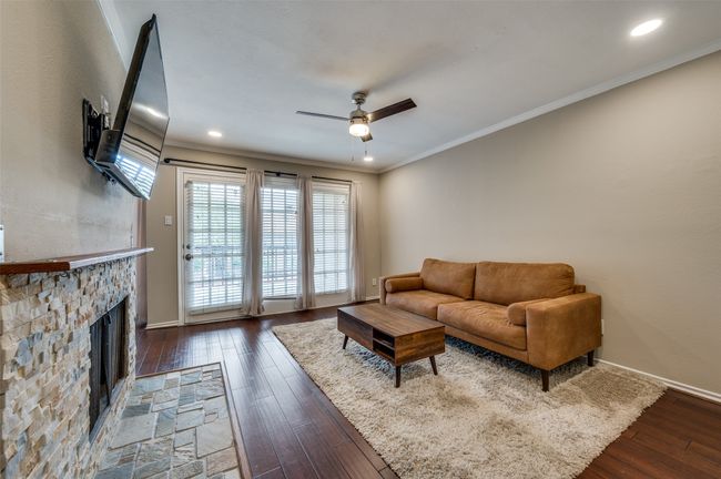 Living area with a ceiling fan, dark wood finished floors, healthy amount of natural light, ornamental molding, and recessed lighting | Image 6