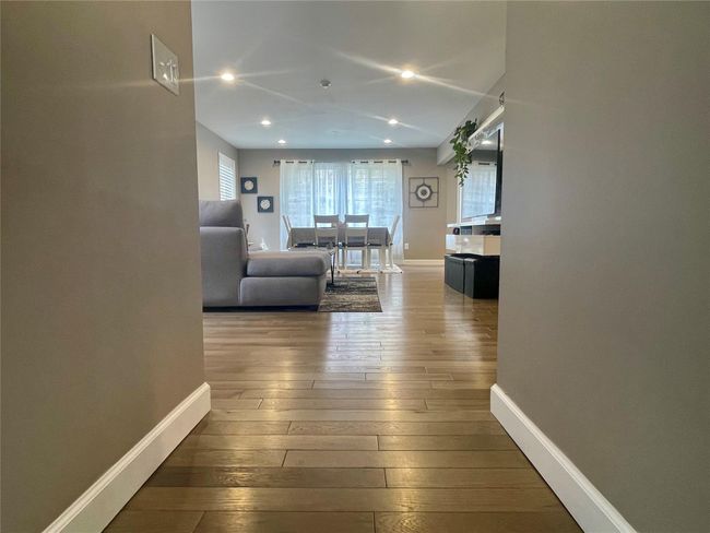 Hall with wood-type flooring, baseboards, and recessed lighting | Image 5