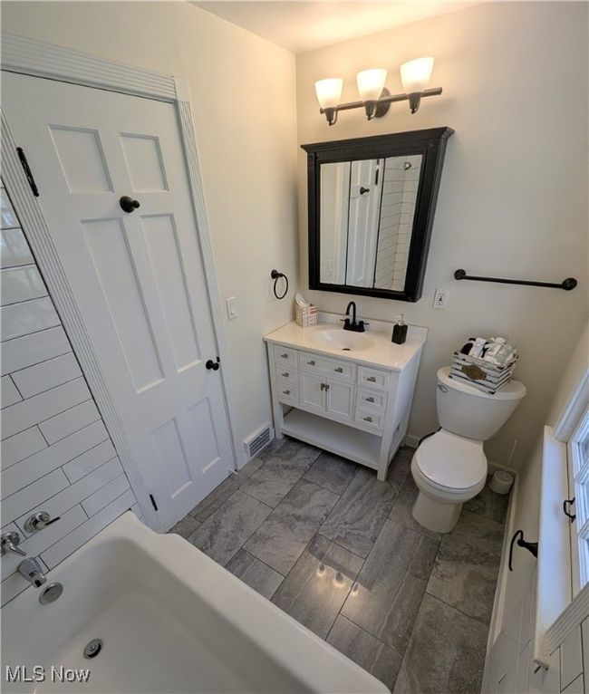 Bathroom with vanity, visible vents, marble finish floor, toilet, and baseboards | Image 8
